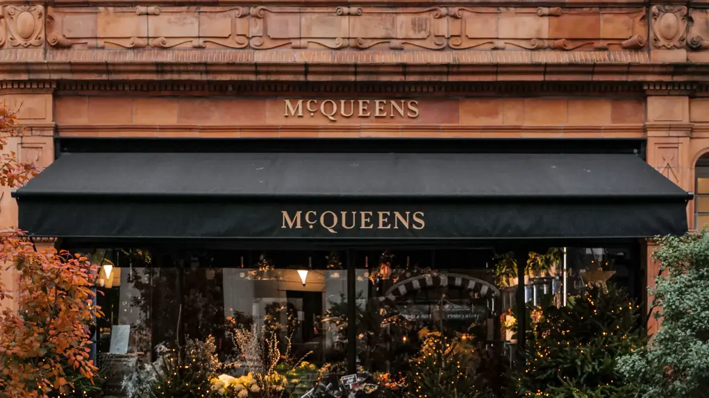 McQueens storefront on Brook Street Mayfair, decorated with seasonal flowers and lights