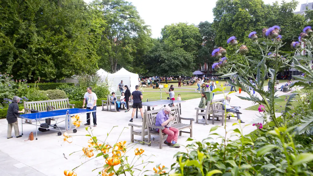 Visitors enjoying outdoor activities and greenery in Grosvenor Square, Mayfair, London