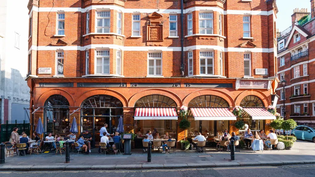 The front of Plants by Deliciously Ella restaurant showing alfresco dining