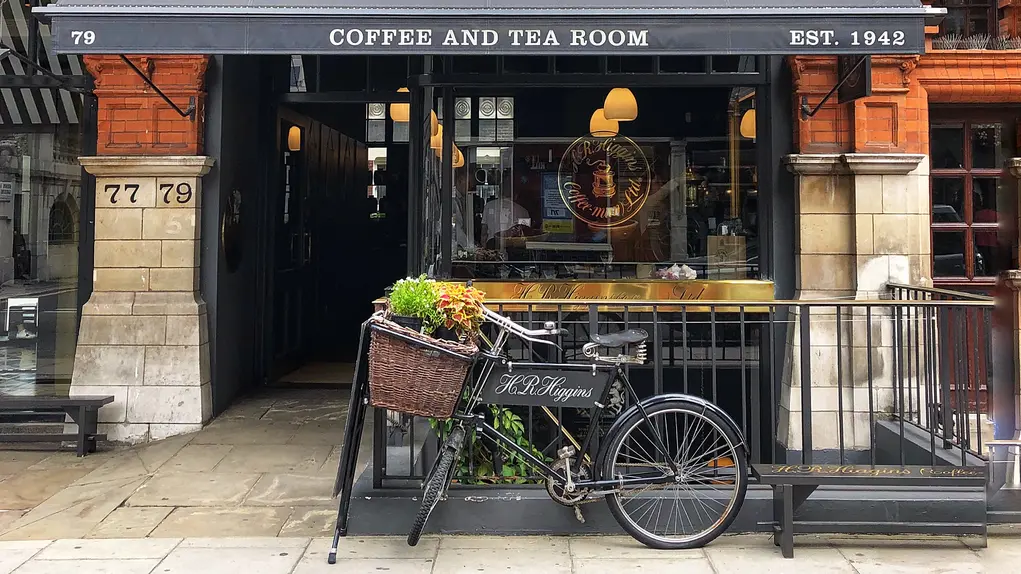 Coffee shop with a bicycle outside and a black awning