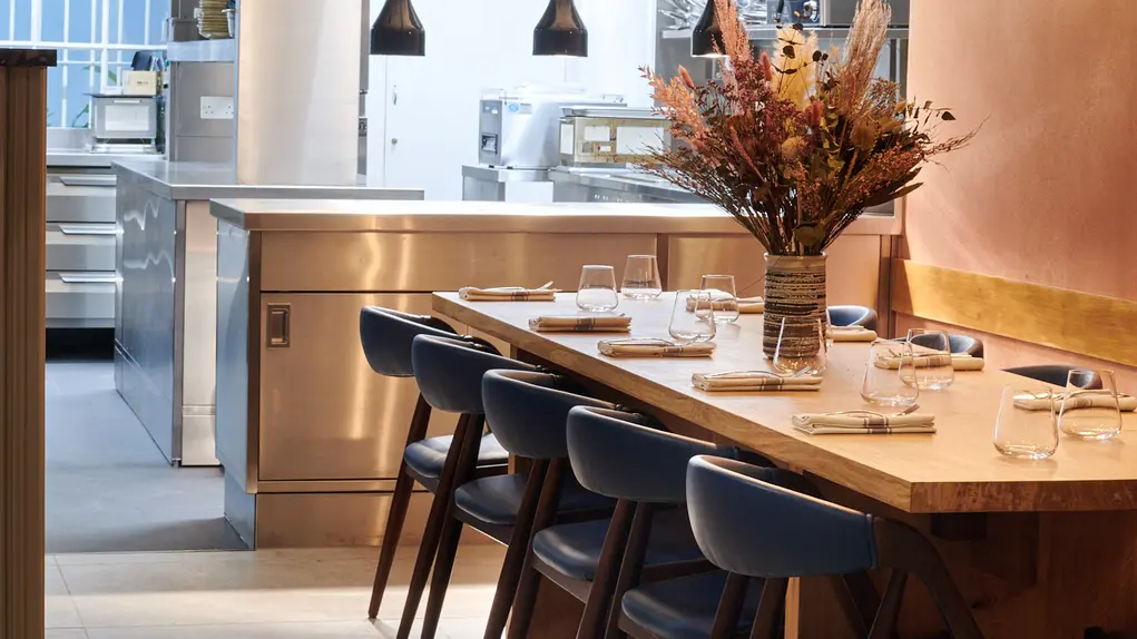 A long table topped with a vase of flowers