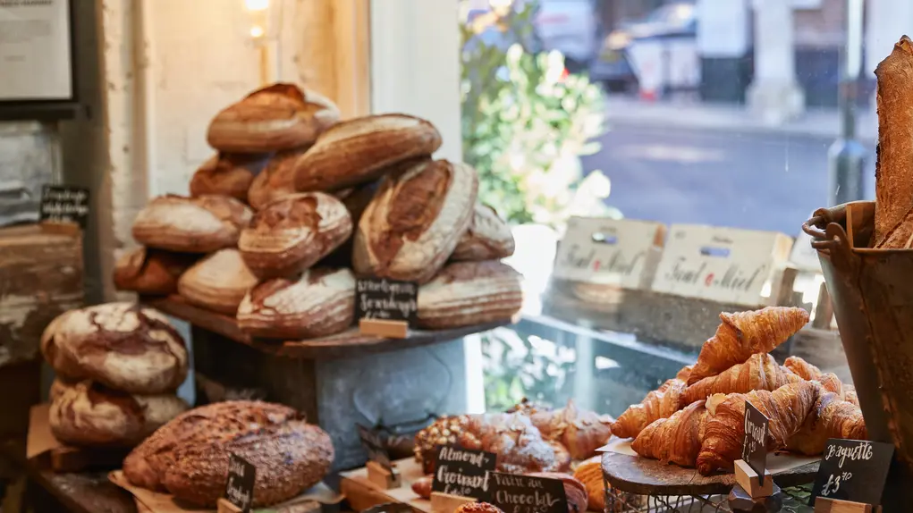 A counter stacked with bread