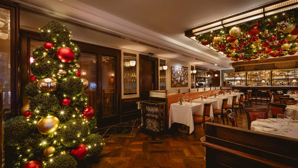 A large dining room with a Christmas tree and decorations