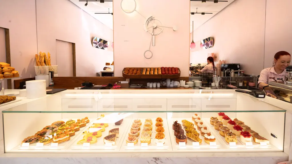A large counter filled with cakes