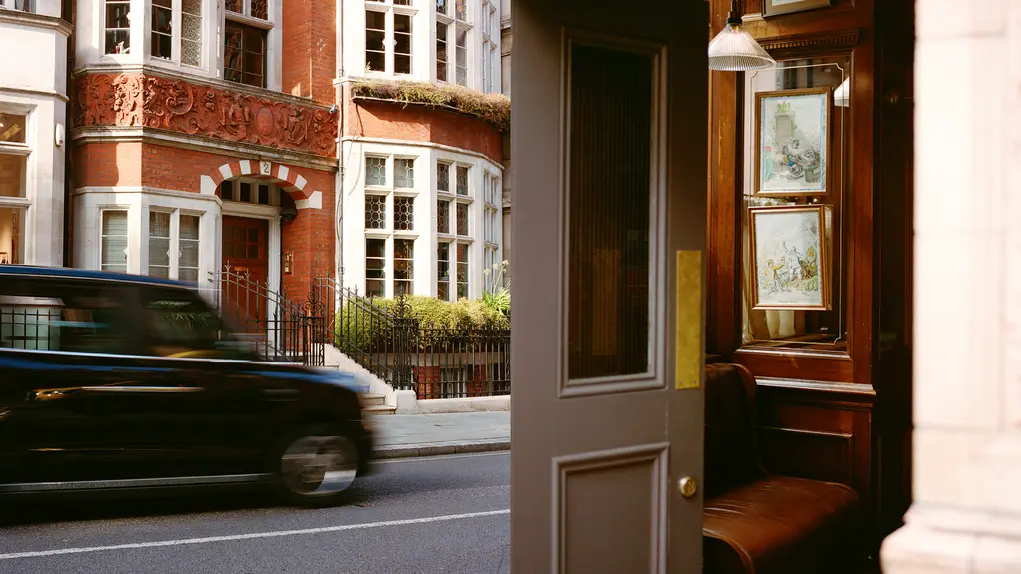 Two images showing a black cab and the inside of a pub