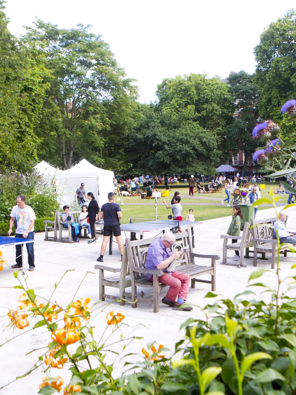 Visitors enjoying outdoor activities and greenery in Grosvenor Square, Mayfair, London