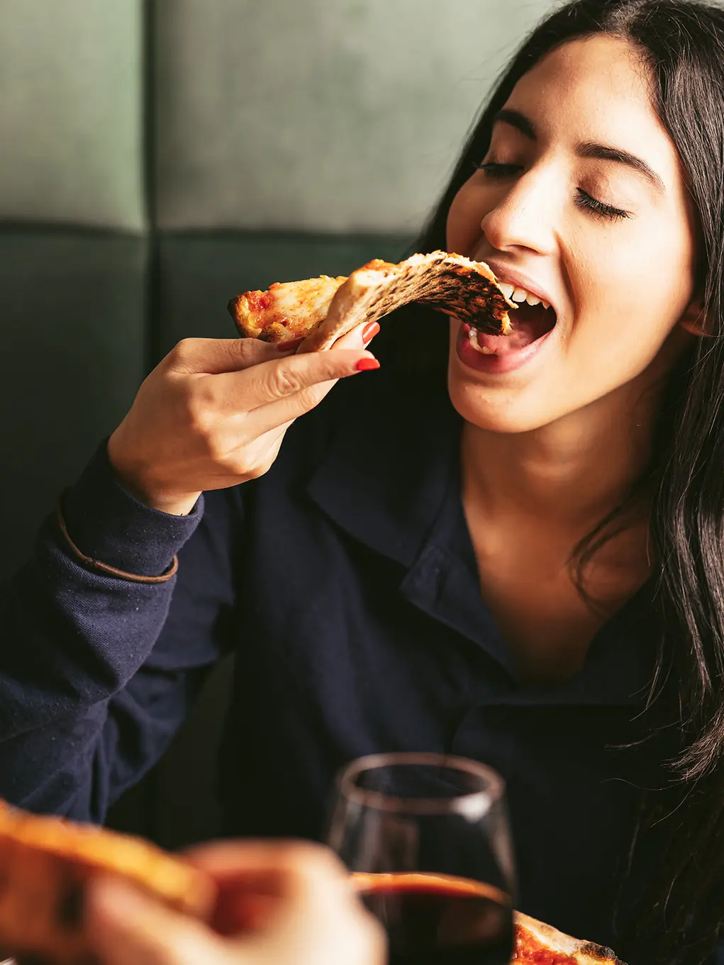 Woman eating pizza