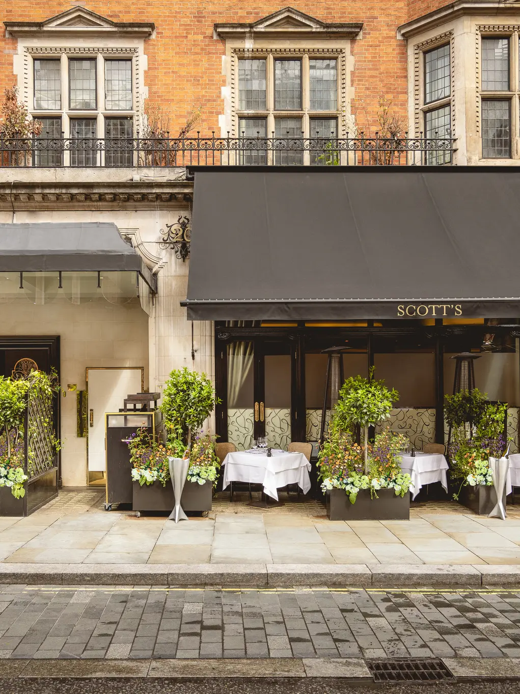 The exterior of Scott's with outdoor seating
