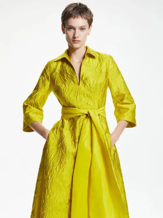 A woman in a yellow long sleeved dress