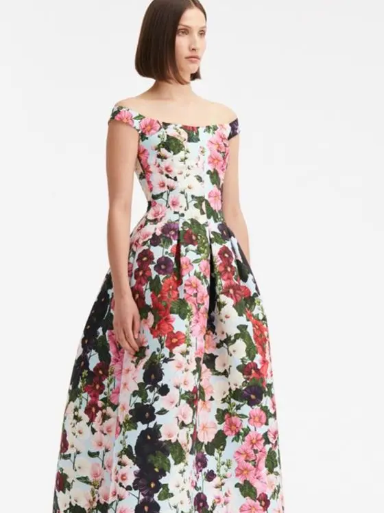 A woman wears an off-shoulder floral dress