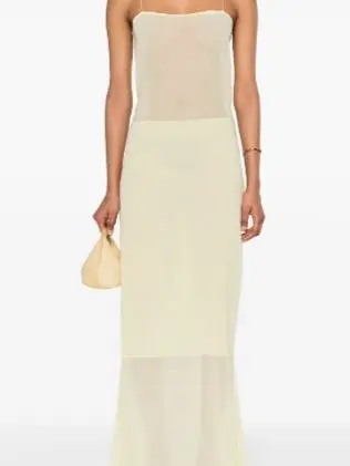 Woman wearing a yellow sleeveless dress