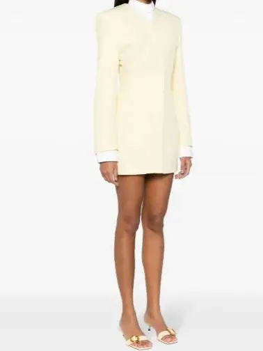 Woman wearing a short yellow long sleeve dress