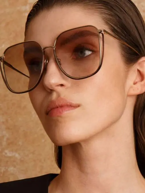 A woman wearing oversized sunglasses