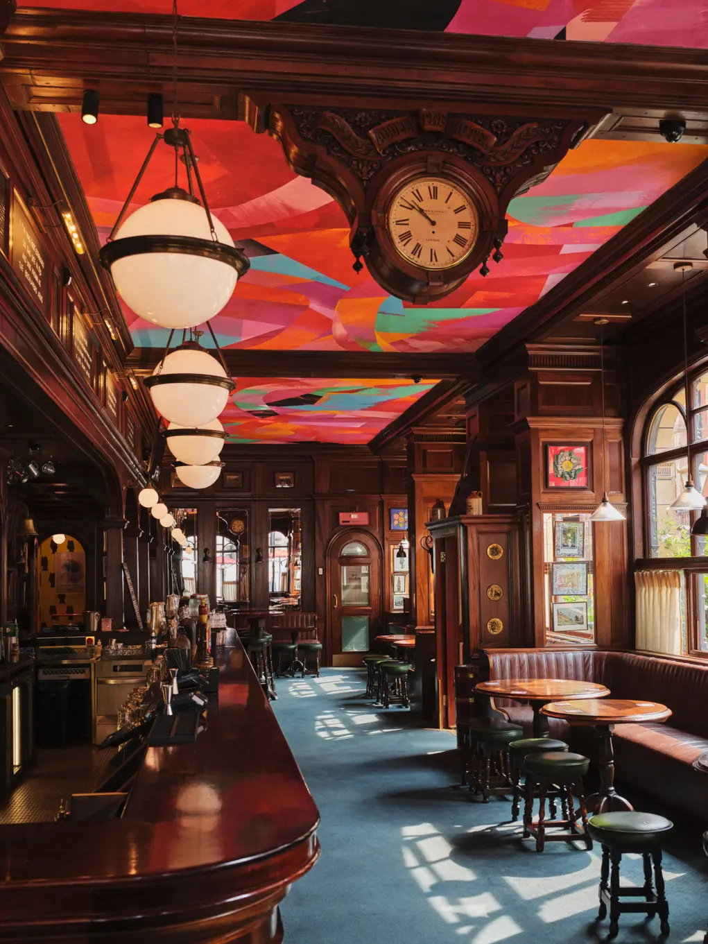 The inside of The Audley Public House with its brightly painted ceiling and mahogany bar
