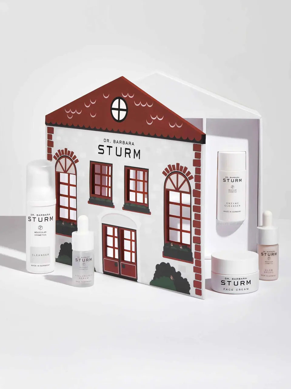 Illustrative townhouse gift box by Dr. Barbara Sturm containing face cleanser, serums, and face cream