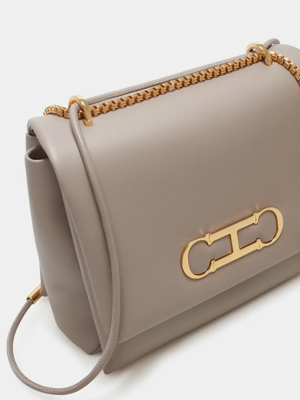 Light brown handbag with gold Carolina Herrera initials