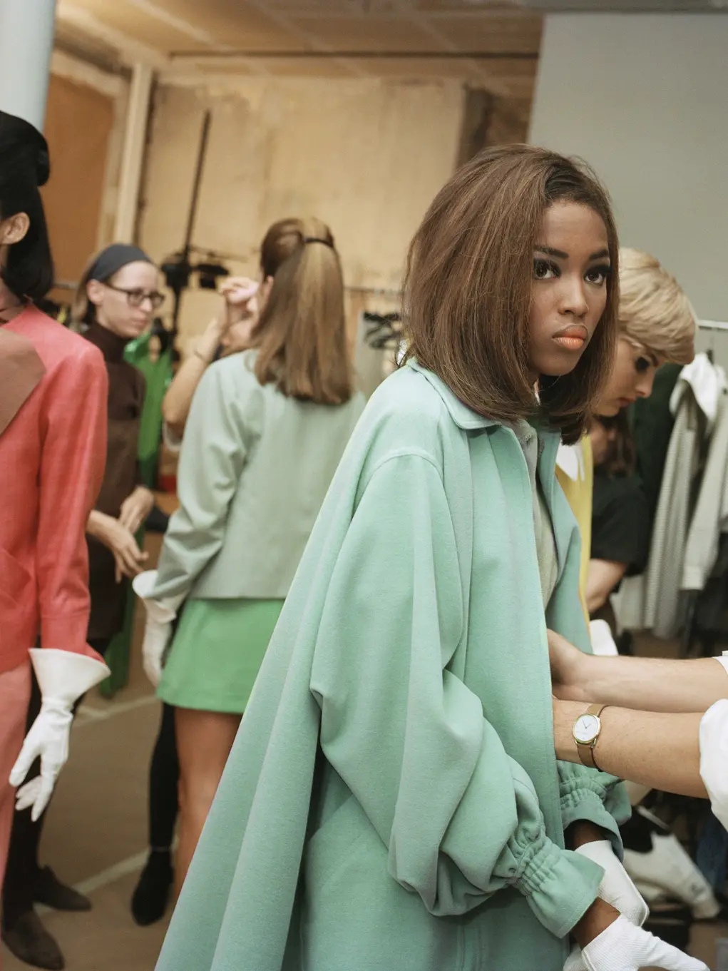 A group of women wearing colourful clothes and a man