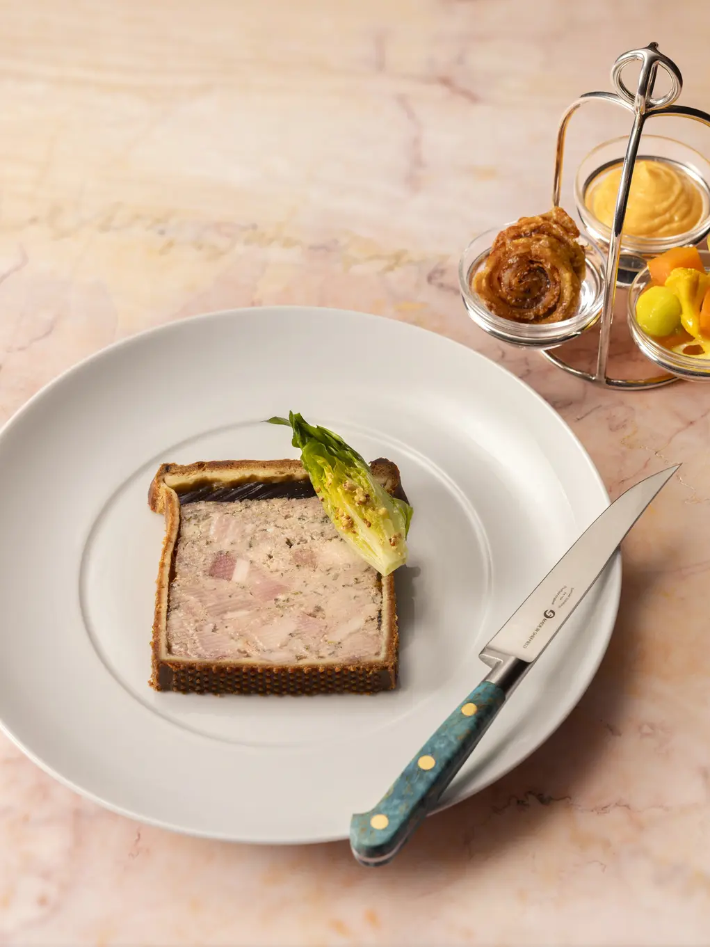 A pork pie on a white plate