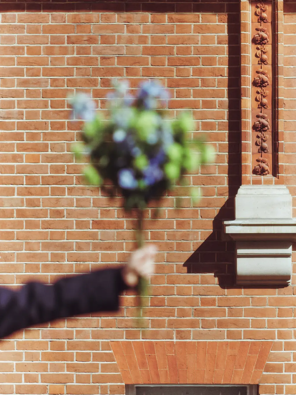 A bouquet of flowers being held by a hand