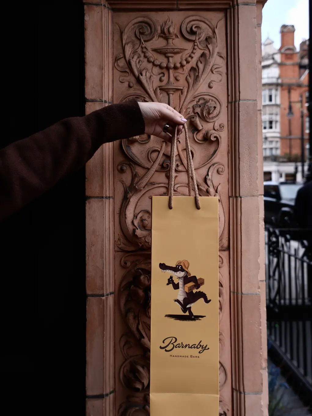 A hand holds up a Barnaby bag