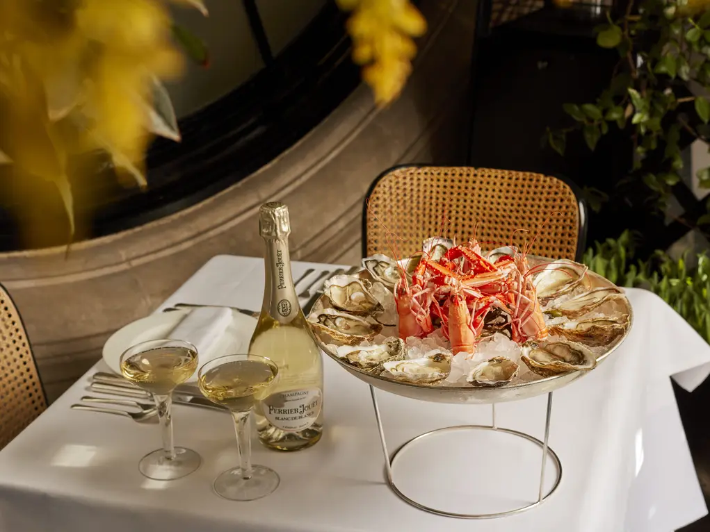 A table filled with champagne and fish at Scott's