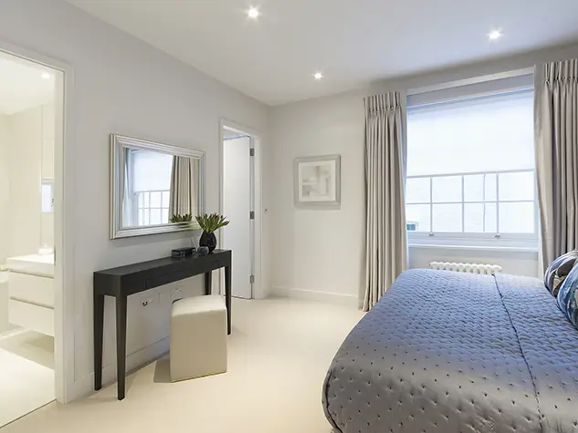 A bedroom with a bed and black table