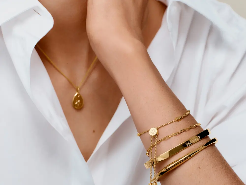A woman's arm with gold bracelets