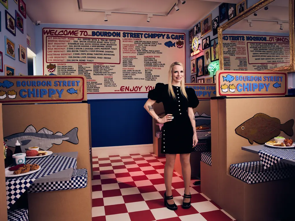 Artist Lucy Sparrow inside her fish and chip shop installation 