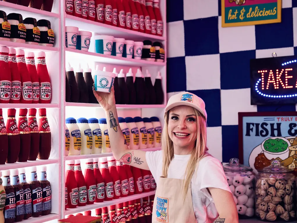 Artist behind the counter of a fish and chip shop