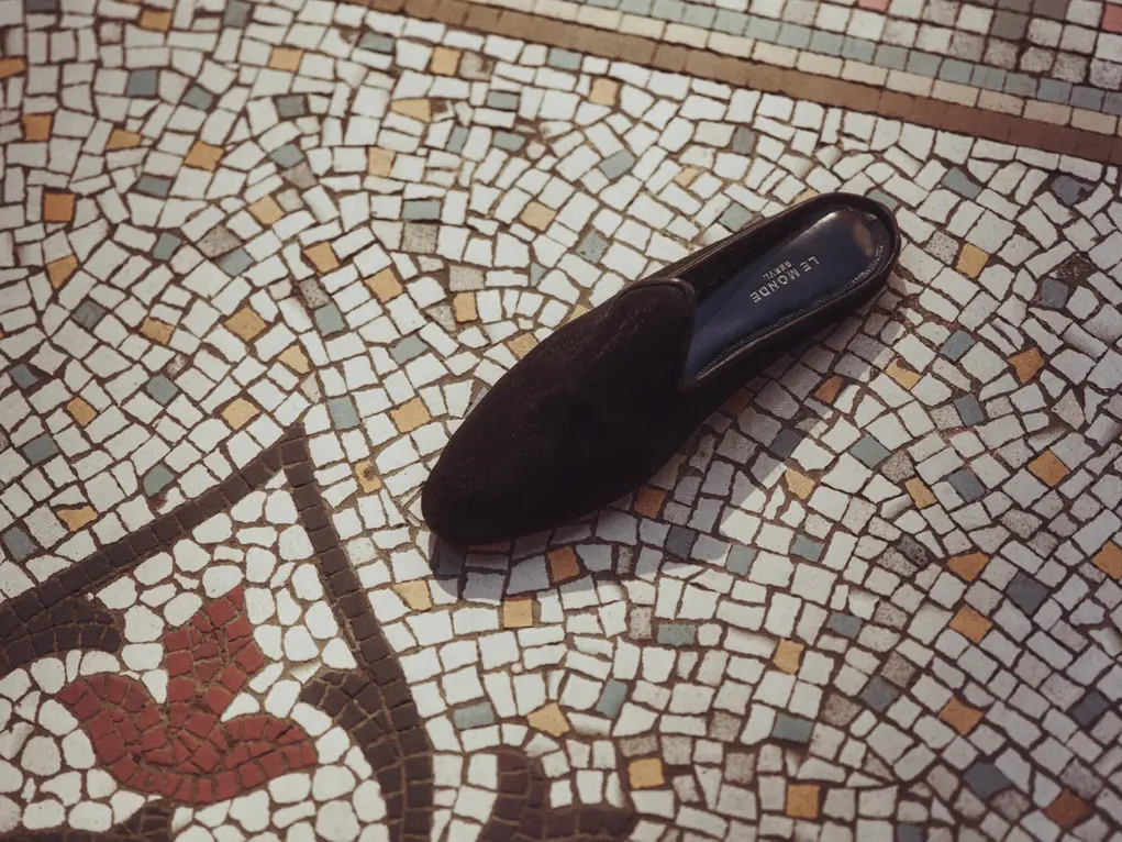 A shoe on a mosaic floor