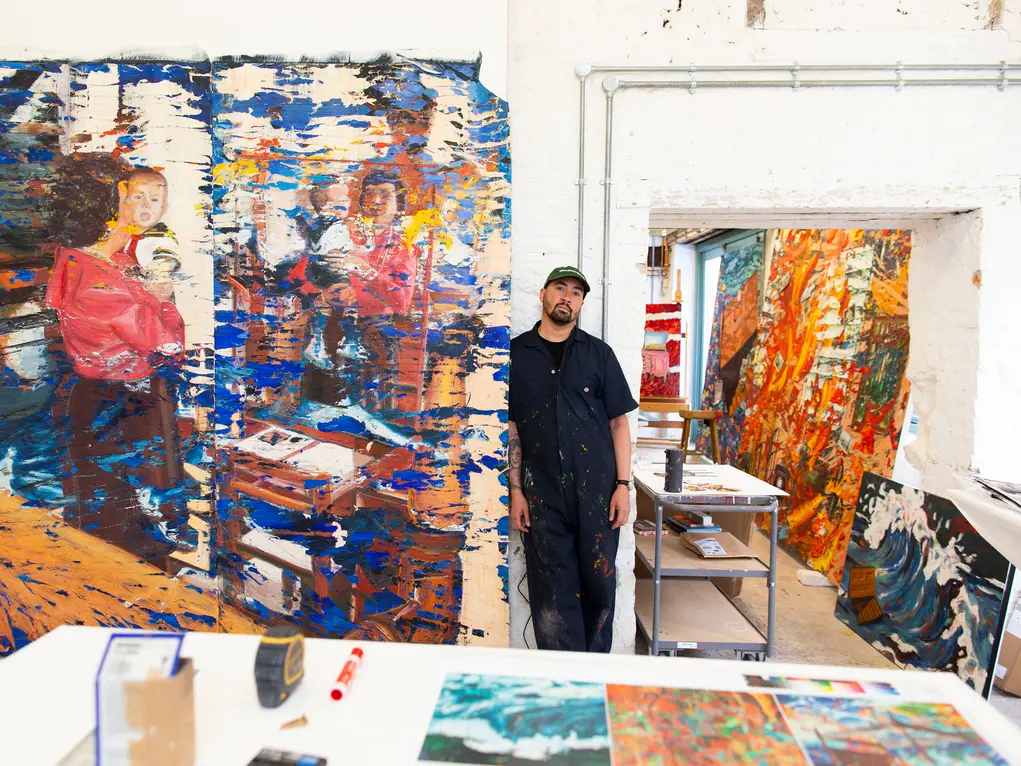 Artist with his paintings